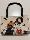 Handmade Halloween tote bag featuring pumpkins, ghosts, bats, a black cat and a handmade bat accessory.